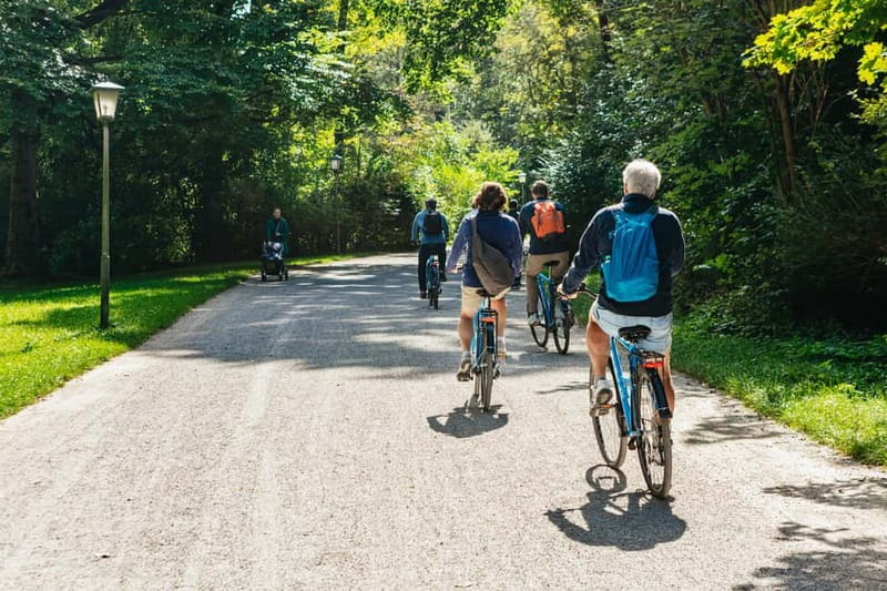 Munich: Classic Guided City Tour by Bike (English Tour Only) - English Garden: the Eisbach River surfers, planned at the right moment